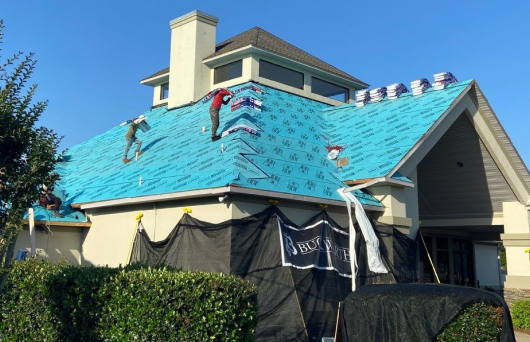 Buckworth Roofing crew performing a roof replacement on a residential home in Pensacola, Florida with professional safety and installation standards