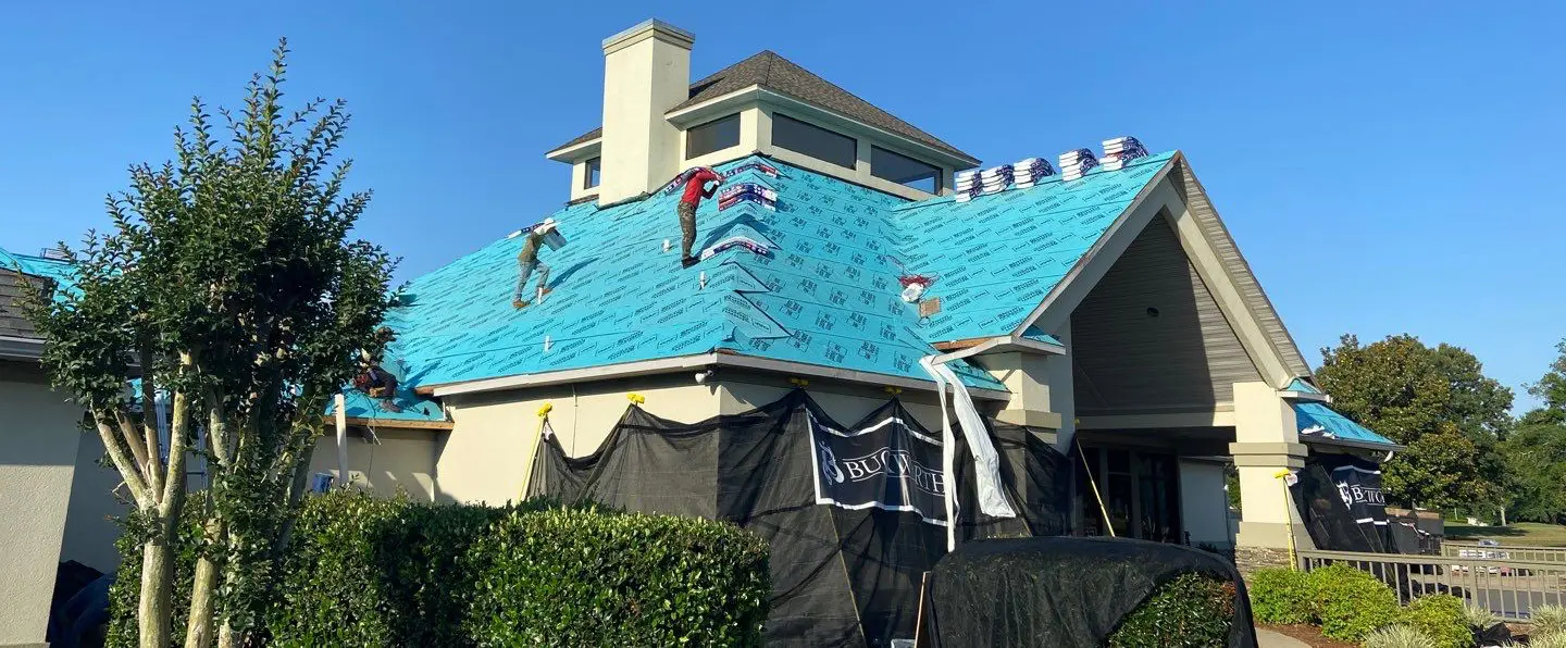 Buckworth Roofing crew performing a roof replacement on a residential home in Pensacola, Florida with professional safety and installation standards